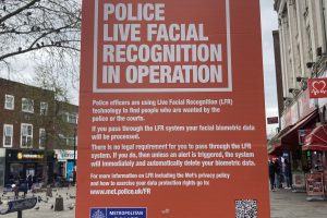 A poster warning about a live facial recognition trial