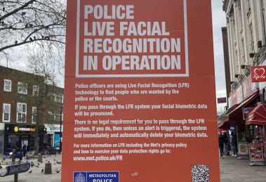 A poster warning about a live facial recognition trial