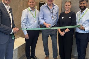 Cutting the ribbon on the new sauna is Edward Smith, the council's cabinet member for council assets