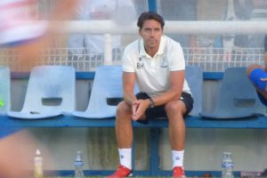 Billy Holland in the dugout at The Dave Bryant Stadium for the opening home game of the season
