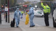 Detectives remove evidence from the crime scene in Hertford Road