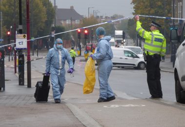 Detectives remove evidence from the crime scene in Hertford Road
