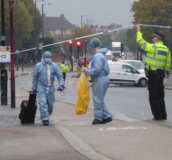 Detectives remove evidence from the crime scene in Hertford Road